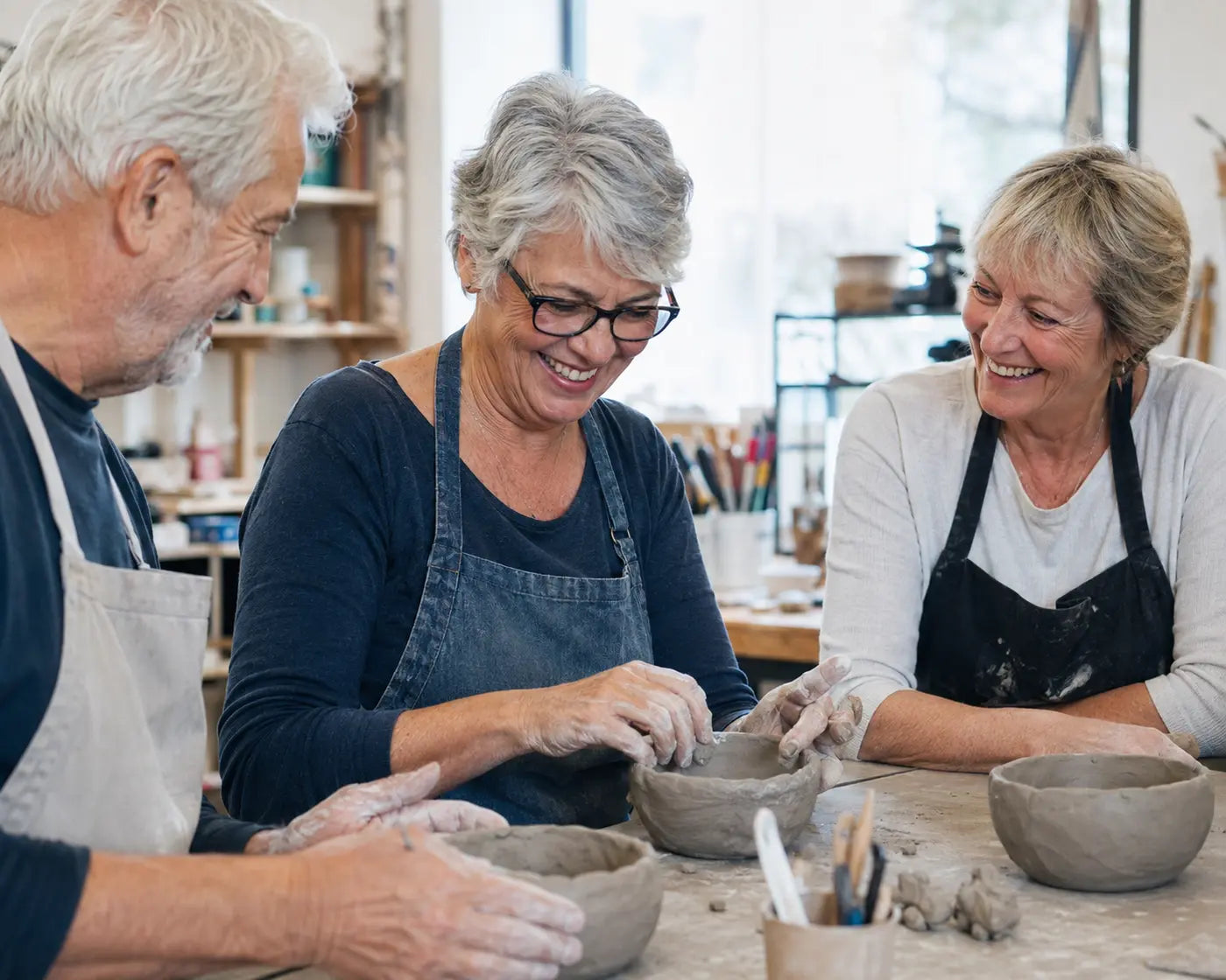 Adults 55 and older making pottery together